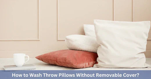 Four throw pillows of varying colors and textures stacked next to a white coffee mug on a minimalist floor setting.