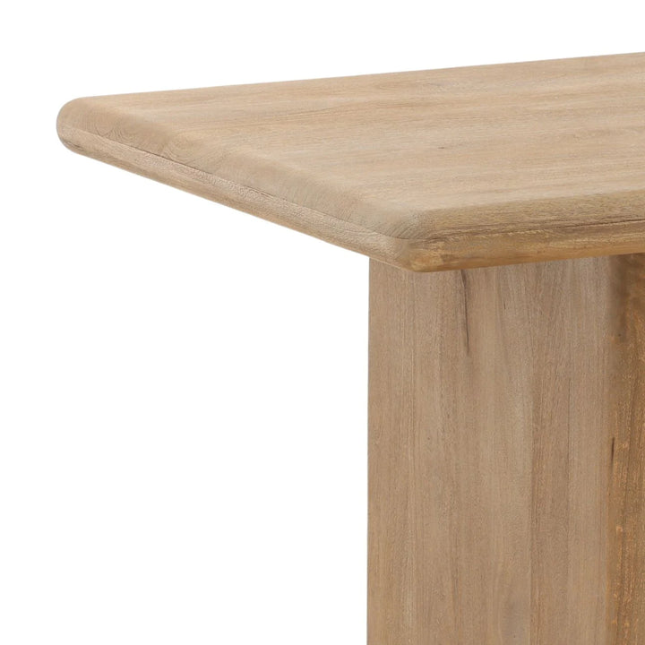 Close-up of natural wood bench corner showing rounded edge detail and slab leg construction on white background