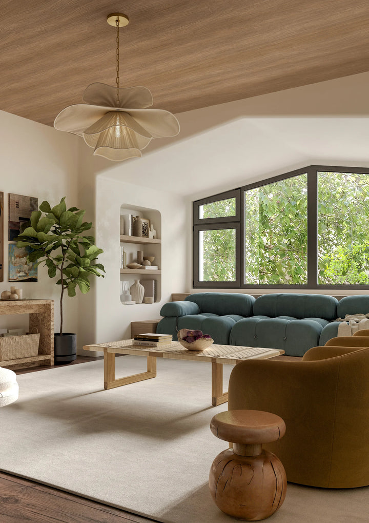 A large, layered leaf-inspired chandelier with four undulating cotton-string shades in a bright living room setting.