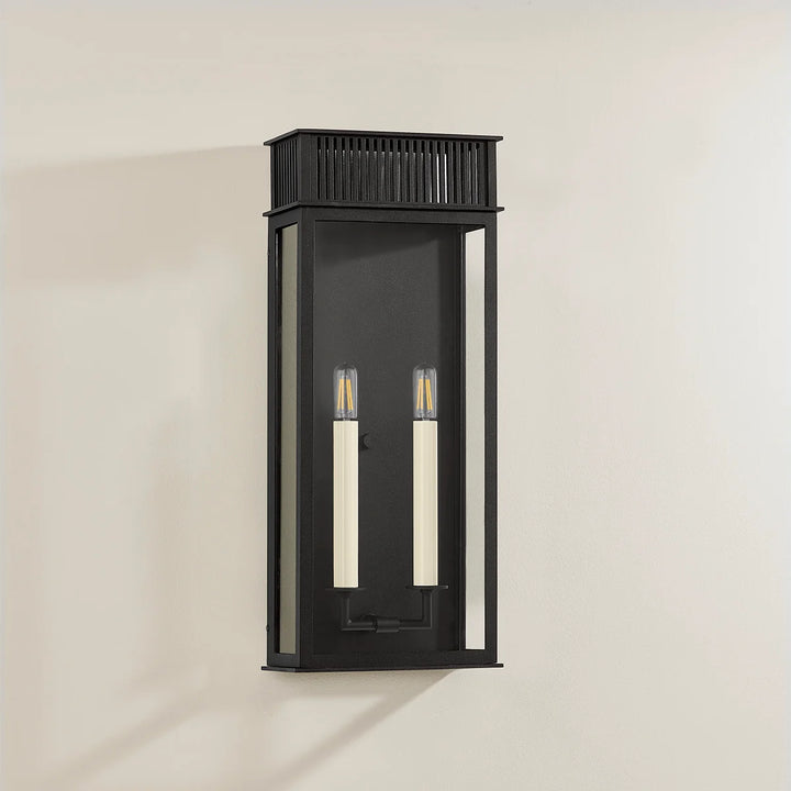 Gridley Exteriors Wall Sconce: Inspired by vintage gas lanterns, this fixture features a slim, modern box silhouette with a decorative vented roof and clear glass panels that offer an unobstructed view of its candle-like sockets.
