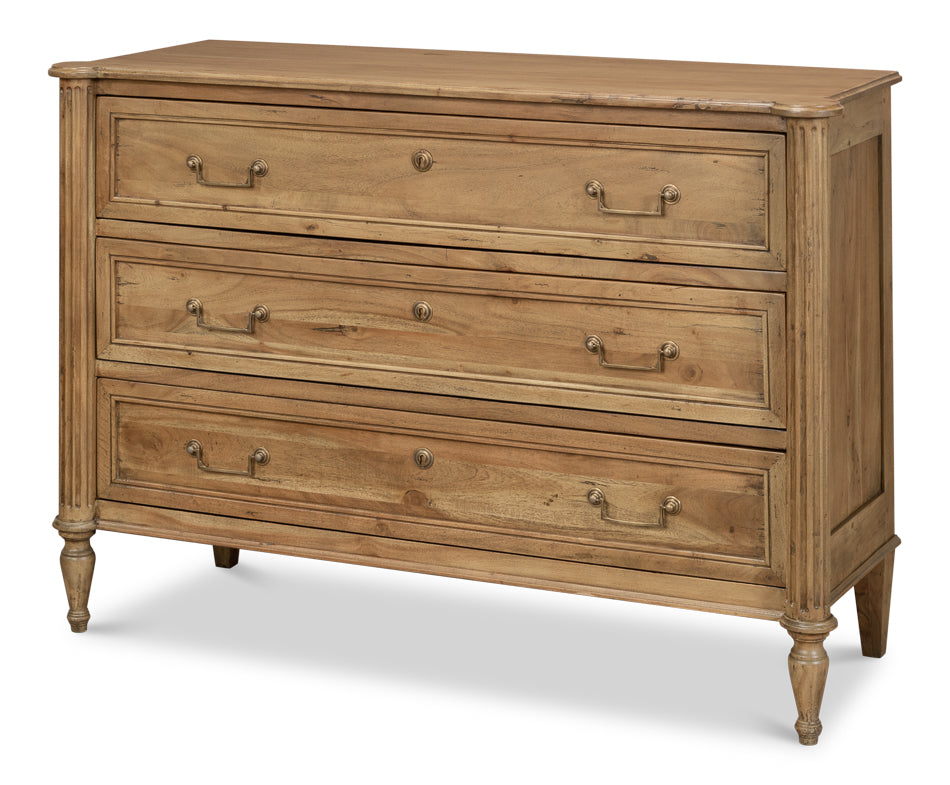 Light wood dresser with three wide drawers, antique brass pulls, and turned legs, rustic farmhouse bedroom chest isolated on white background