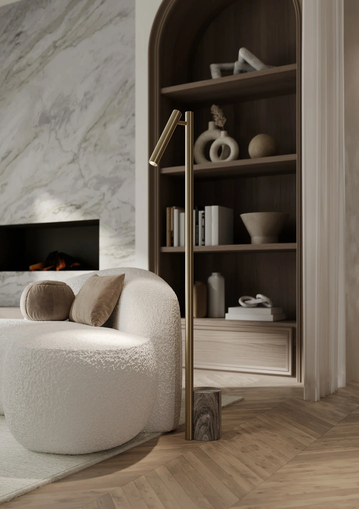Circleville Floor Lamp: A minimalist fixture with a slender metallic stem and an adjustable dome shade.