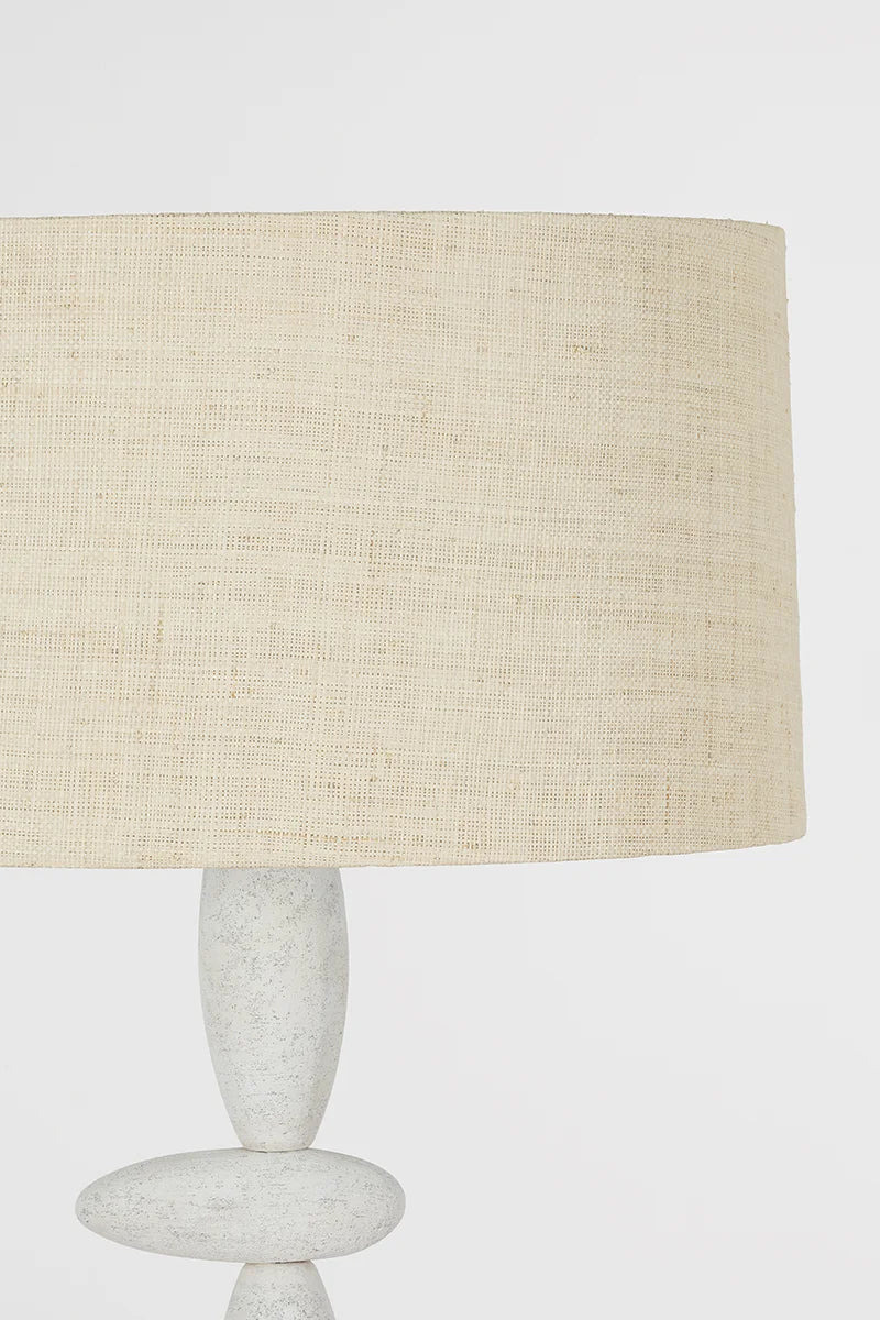 Cullen Floor Lamp: A totemic, sculptural light featuring off-center ceramic "stones" and a woven shade.