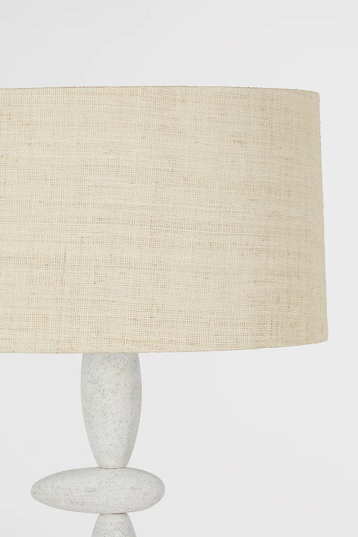 Cullen Floor Lamp: A totemic, sculptural light featuring off-center ceramic "stones" and a woven shade.