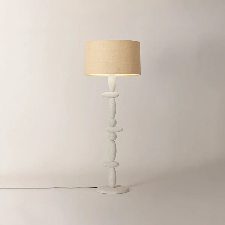 Cullen Floor Lamp with beige drum shade and sculptural white stacked stone base on a light background.