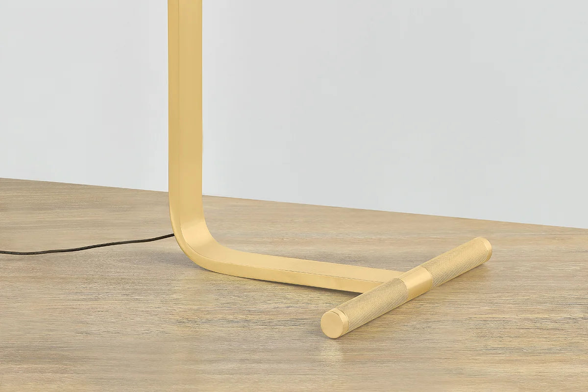 Deptford Floor Lamp: Black dome shade, gold interior, brass joint on white background.