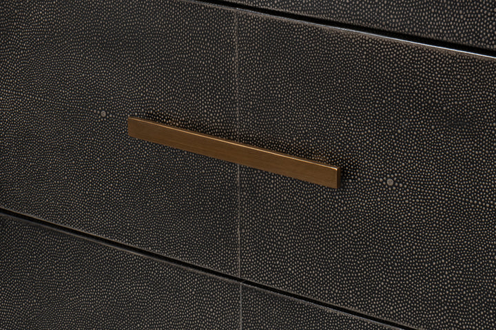 Close-up of dark shagreen textured dresser drawer with brushed brass bar pull handle