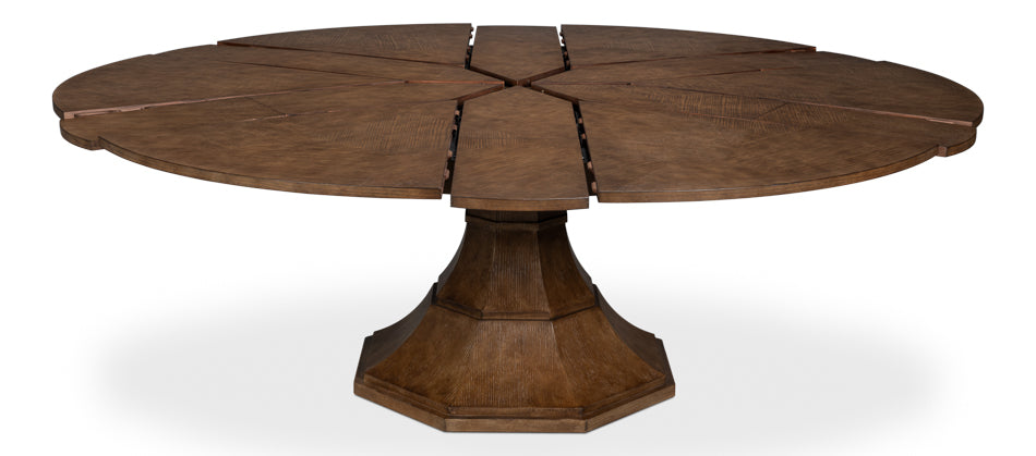 Expandable round pedestal dining table in brown wood with leaf inserts shown partially extended, isolated on white background