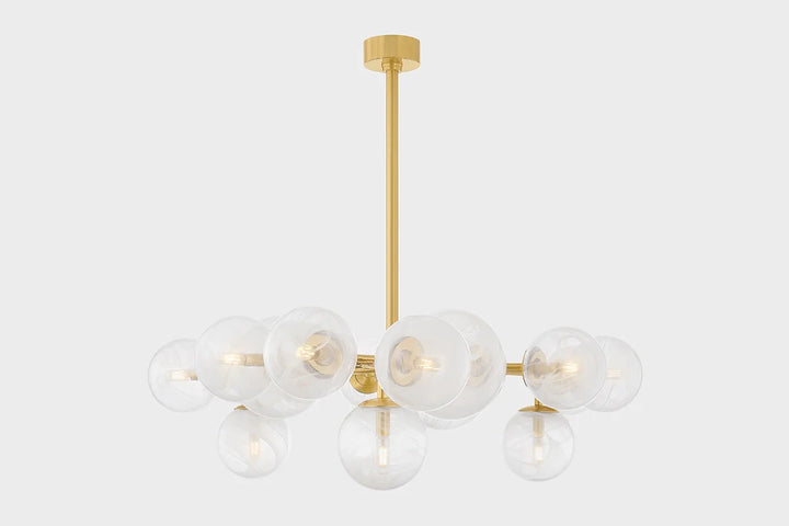 A modern chandelier with a gold branch-inspired frame and clear swirled glass globes, against a white background.