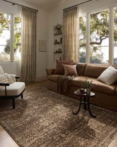 Living room with a brown sofa, armchair, and large windows.