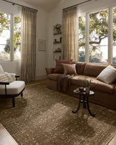 Living room with brown sofa, armchair, and coffee table in a well-lit room.