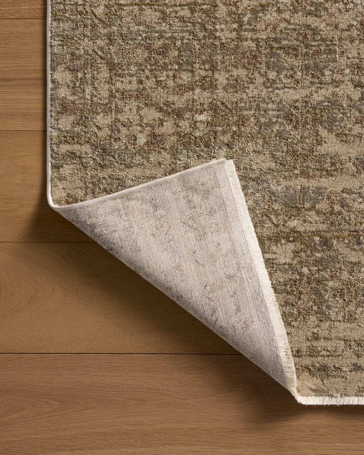 Close-up of a textured rug on wooden flooring