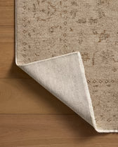 Close-up of a beige carpet corner on a wooden floor