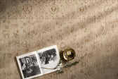 Small book or notebook with a gold object on a textured surface
