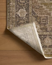 Close-up of a patterned rug corner on a wooden floor