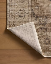 Corner of a patterned rug on a wooden floor
