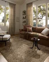 Living room with brown sectional sofa, armchair, and decorative rug.