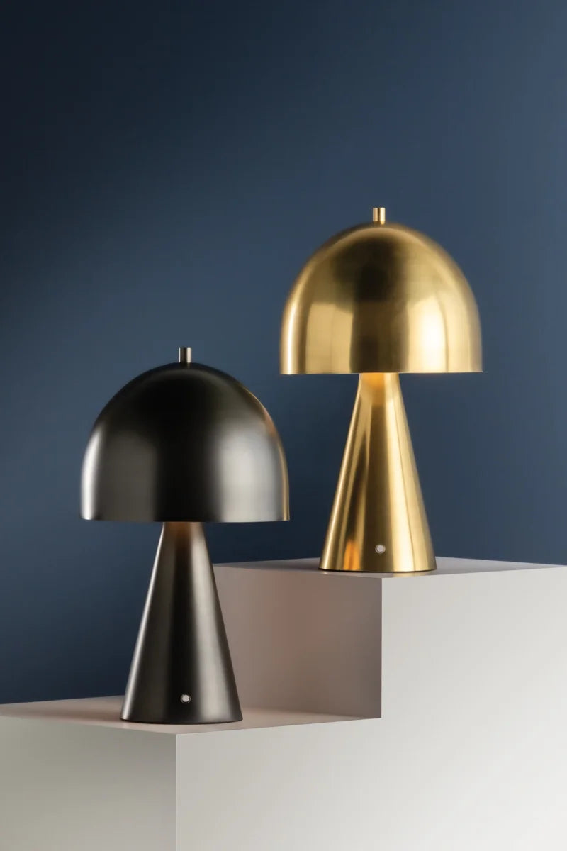 Two portable outdoor table lamps, one in black and one in gold, with a geometric design, displayed against a neutral background.