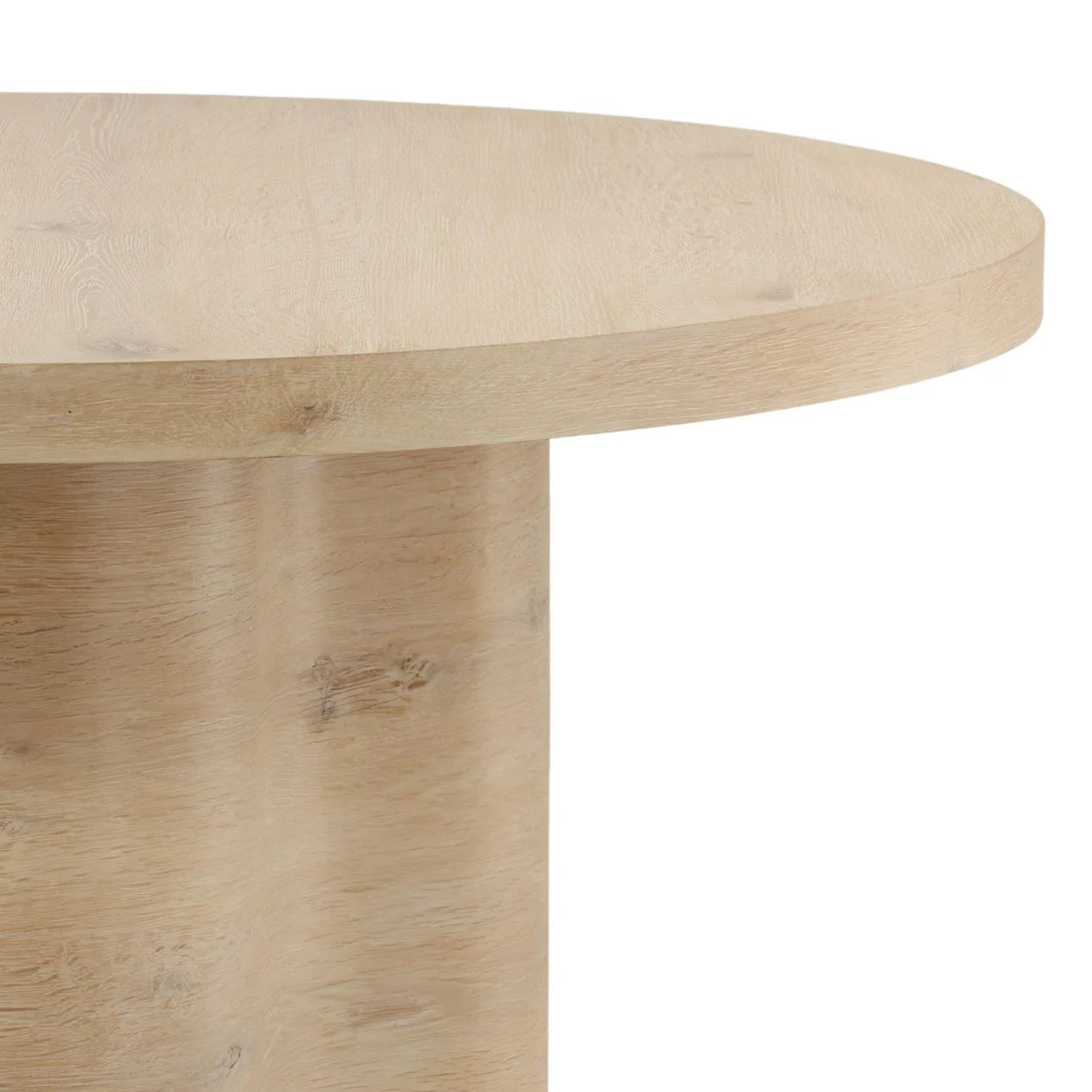 Close up of light wood round table top with pedestal base and natural grain finish