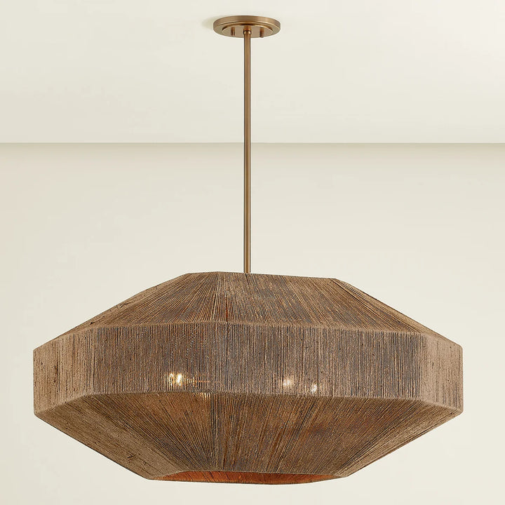 A Laken chandelier with a hand-wrapped jute shade and Patina Brass metalwork, featuring a pinwheel cluster of lights inside.