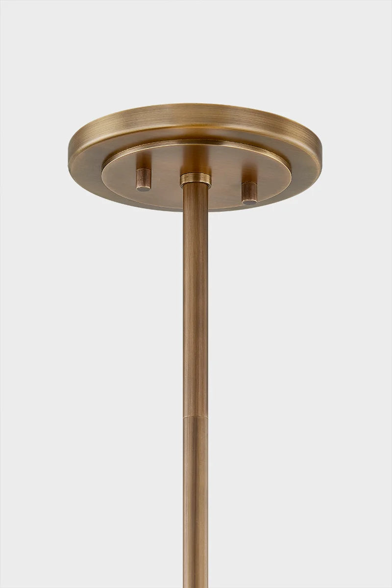 Close-up of brass ceiling canopy and downrod mount for pendant light fixture