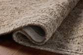 Brown textured rug on a wooden floor