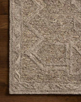 Close-up of a textured brown rug on a wooden floor