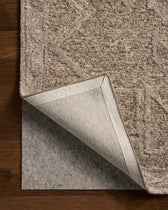 Brown textured rug with a matching border on a wooden floor