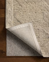 Textured beige rug on a wooden floor