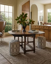 Dining room with wooden table, chairs, and decorative elements.