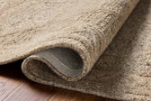 Beige textured rug on a wooden floor