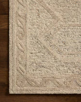 Beige textured rug with a geometric pattern on a wooden floor