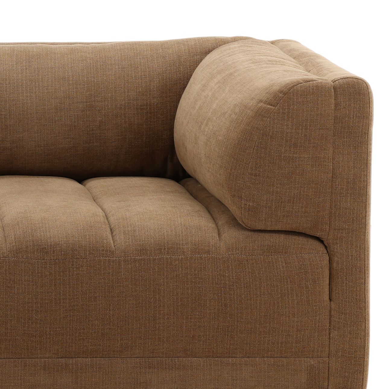 Close up of brown upholstered sofa corner with tufted seat cushion, textured fabric, and oversized armrest pillow