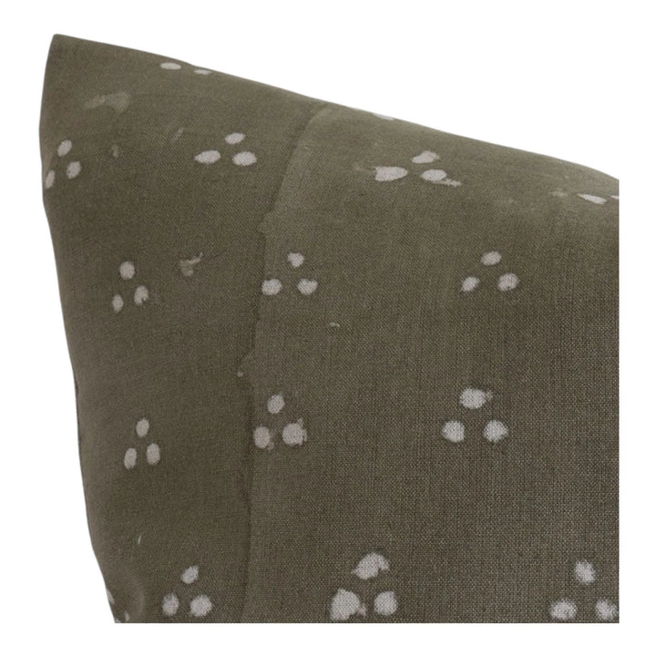 Close up of olive gray throw pillow cover with white dot print and stitched seam detail