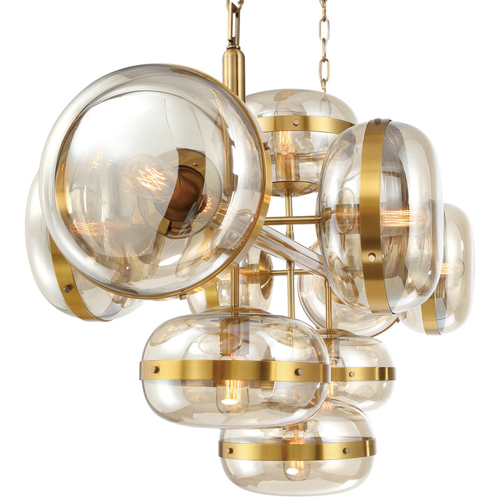 A Nottingham Chandelier featuring clear glass orbs with gold metal bands and vintage-style lighting inside, creating a warm glow.