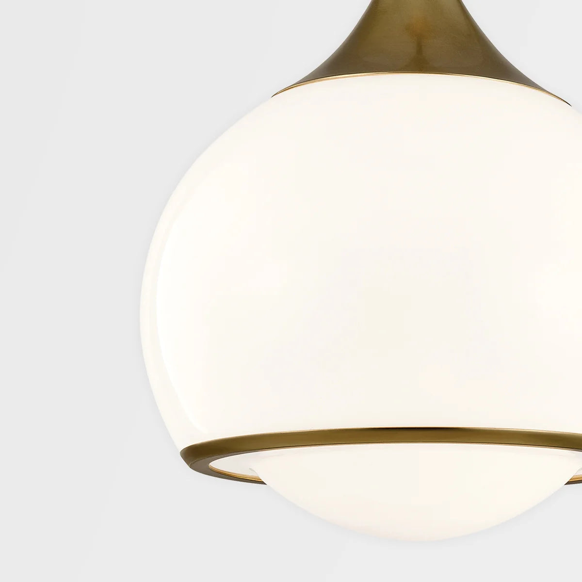 A white globe pendant light with a gold top and bottom, suspended against a neutral background.