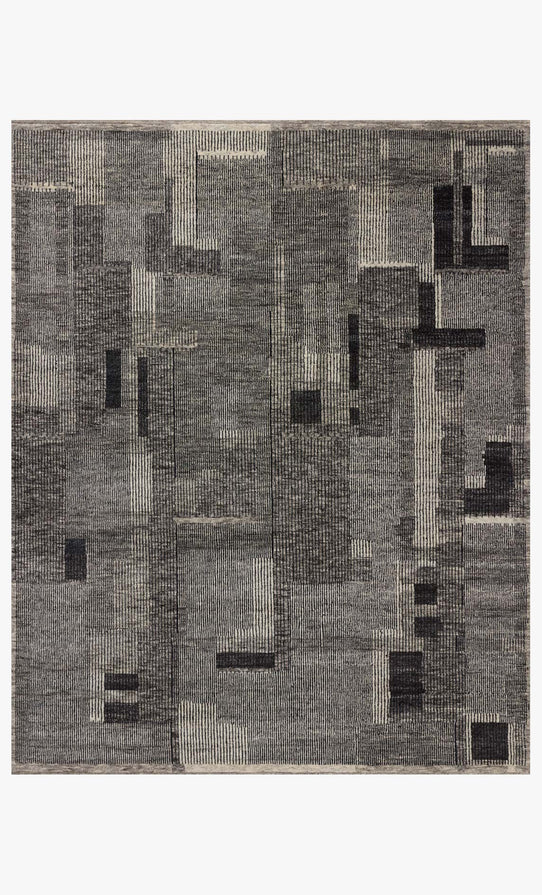 A contemporary hand-knotted wool rug with an overlapping patchwork-style pattern in various shades of charcoal gray.