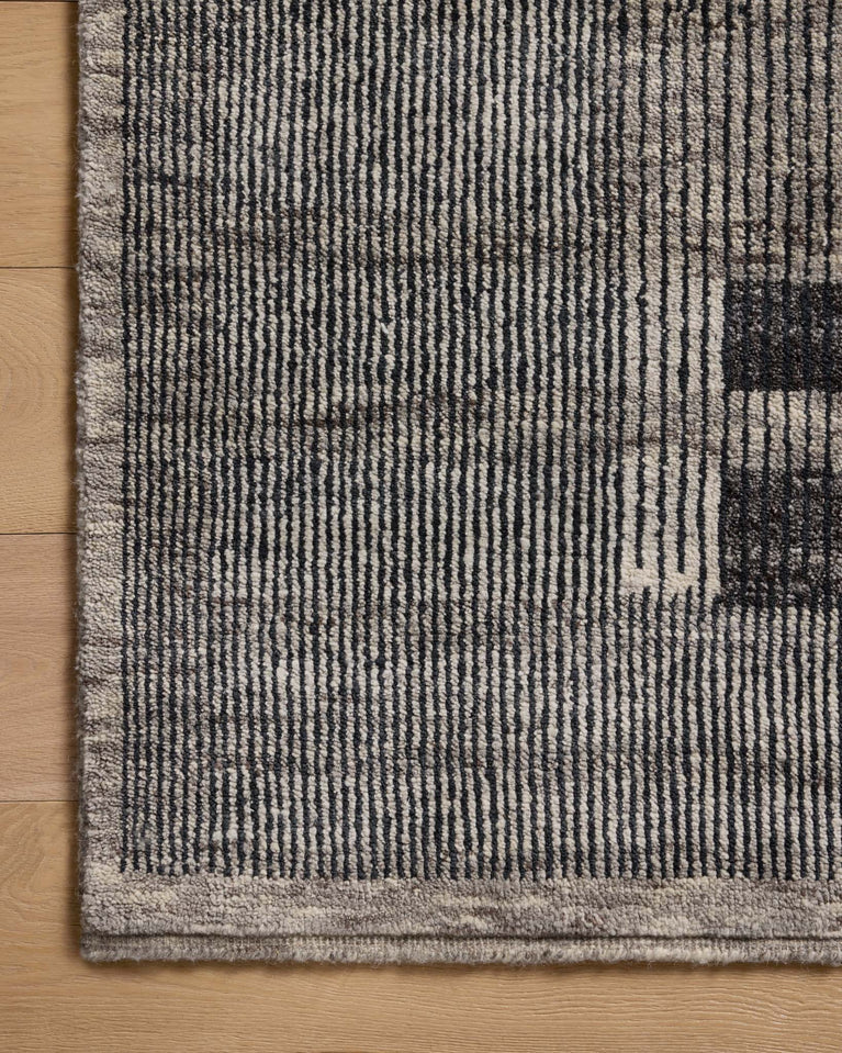 Black and gray striped rug corner close up with textured border