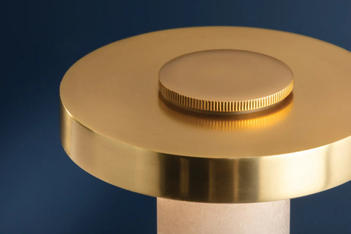 Close up brushed brass lamp finial with knurled knob