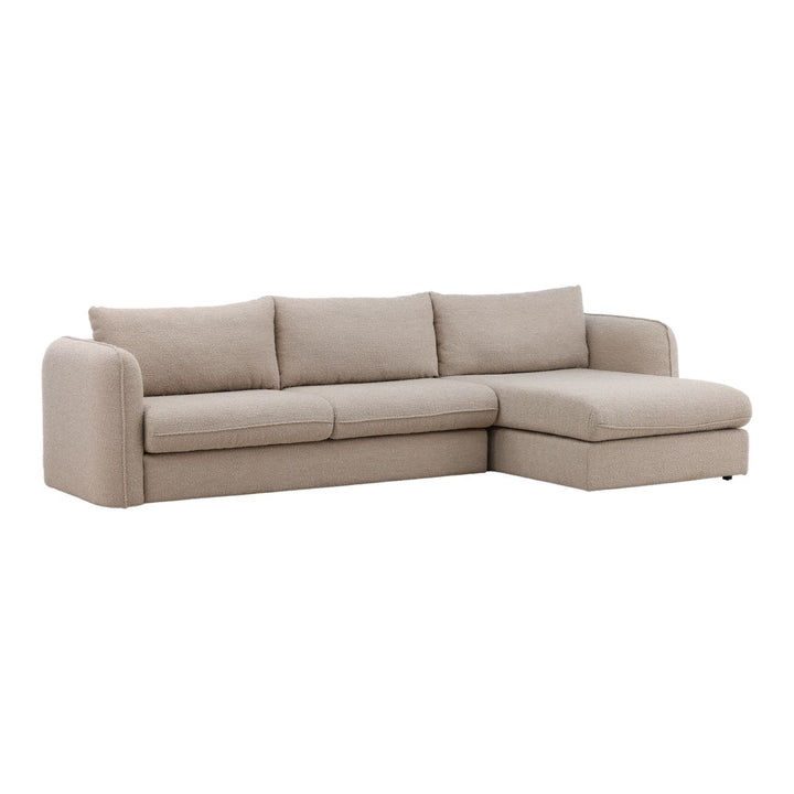 Beige sectional sofa with right-facing chaise and three back cushions, contemporary L-shaped couch isolated on white background