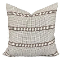 Textured pillow with a geometric pattern on a plain background