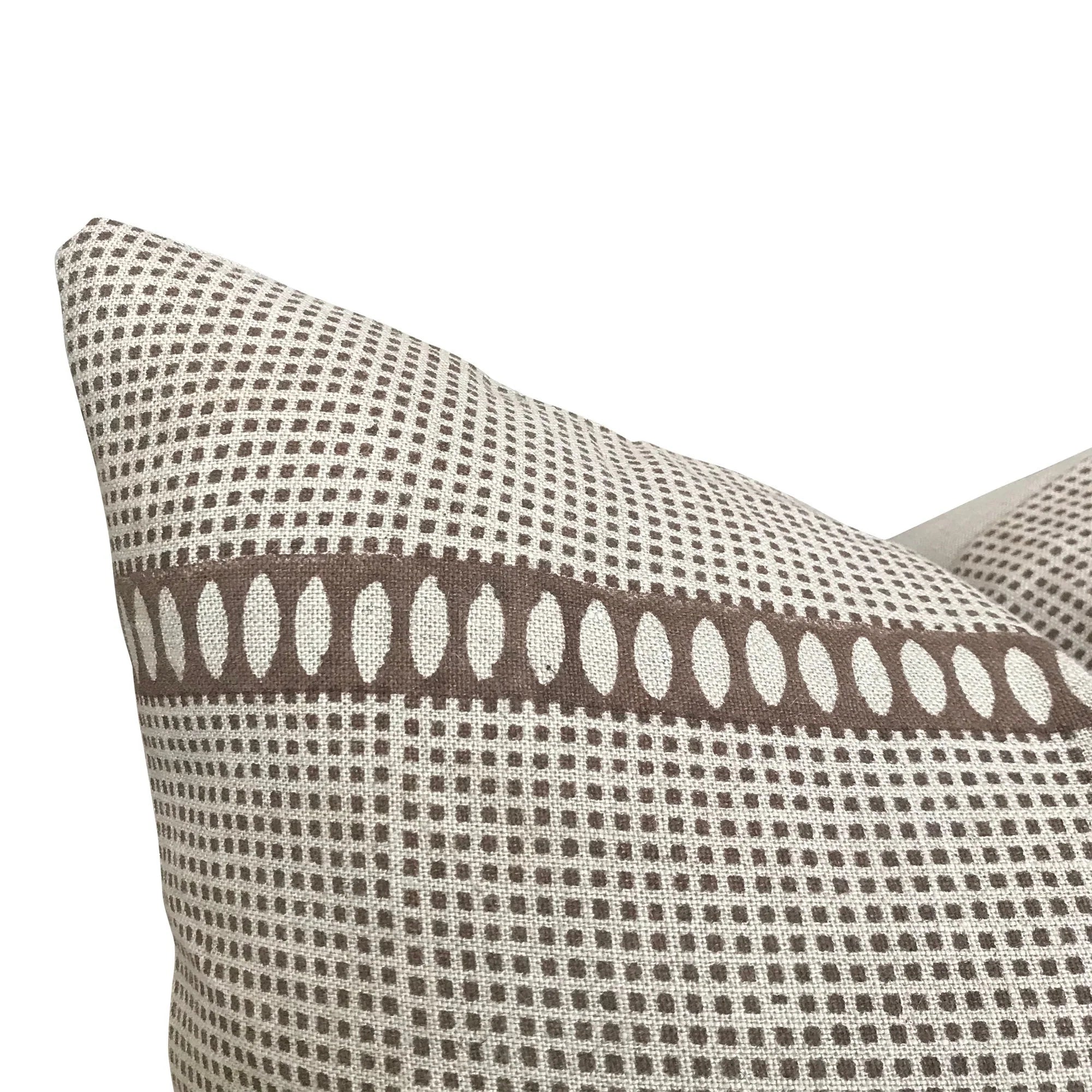 Patterned pillow with brown and beige design on a white background