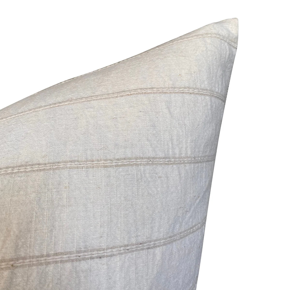 Close-up of a light gray pillow with subtle texture and stitching details on a white background