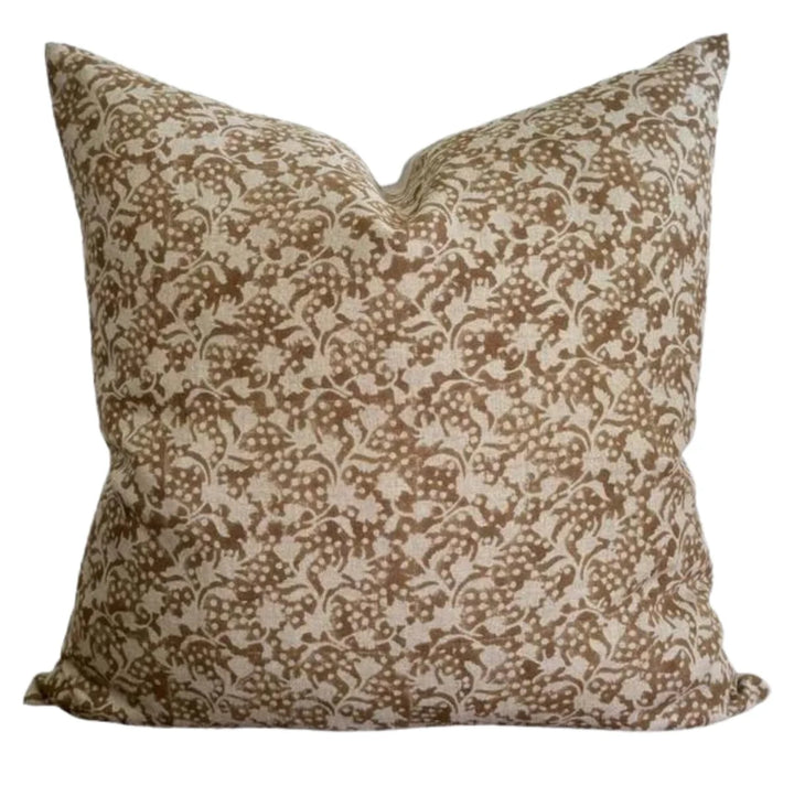 Decorative pillow with brown and beige floral pattern on a white background