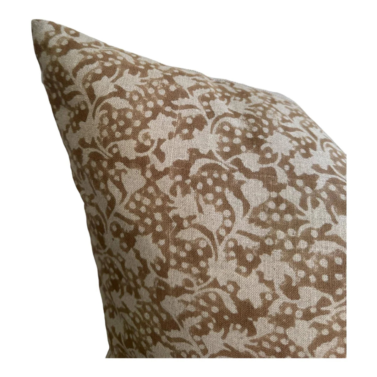 Decorative pillow with brown and beige floral pattern on a white background