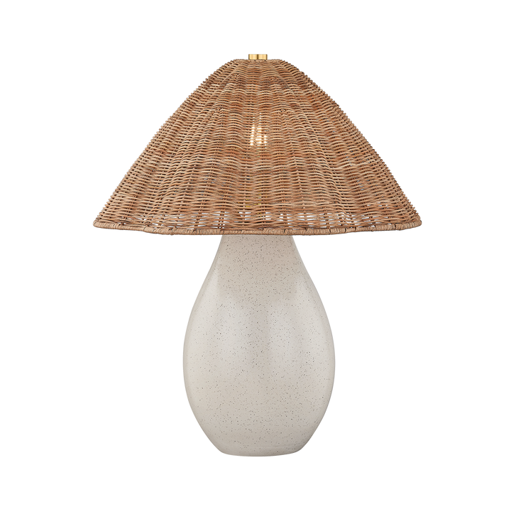 Table lamp with a textured white base and wicker shade on a white background