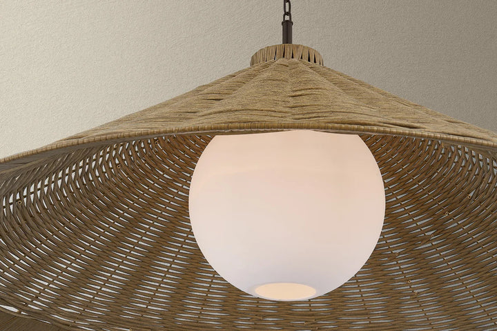 Wicker pendant light with a white bulb against a neutral background