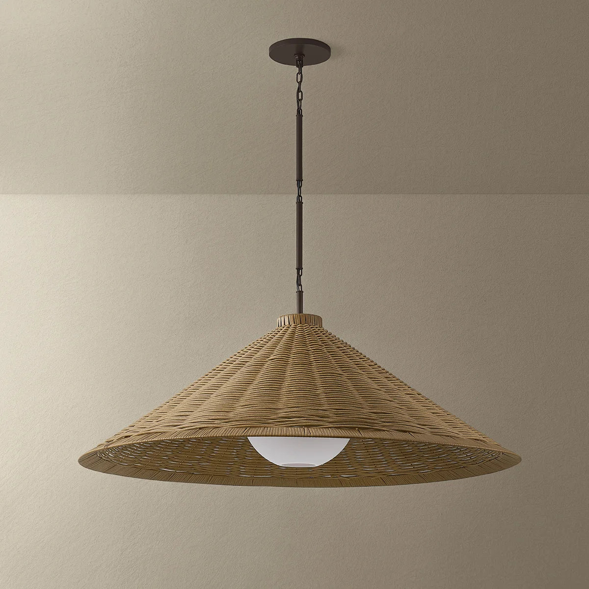 Wicker pendant light hanging against a beige wall