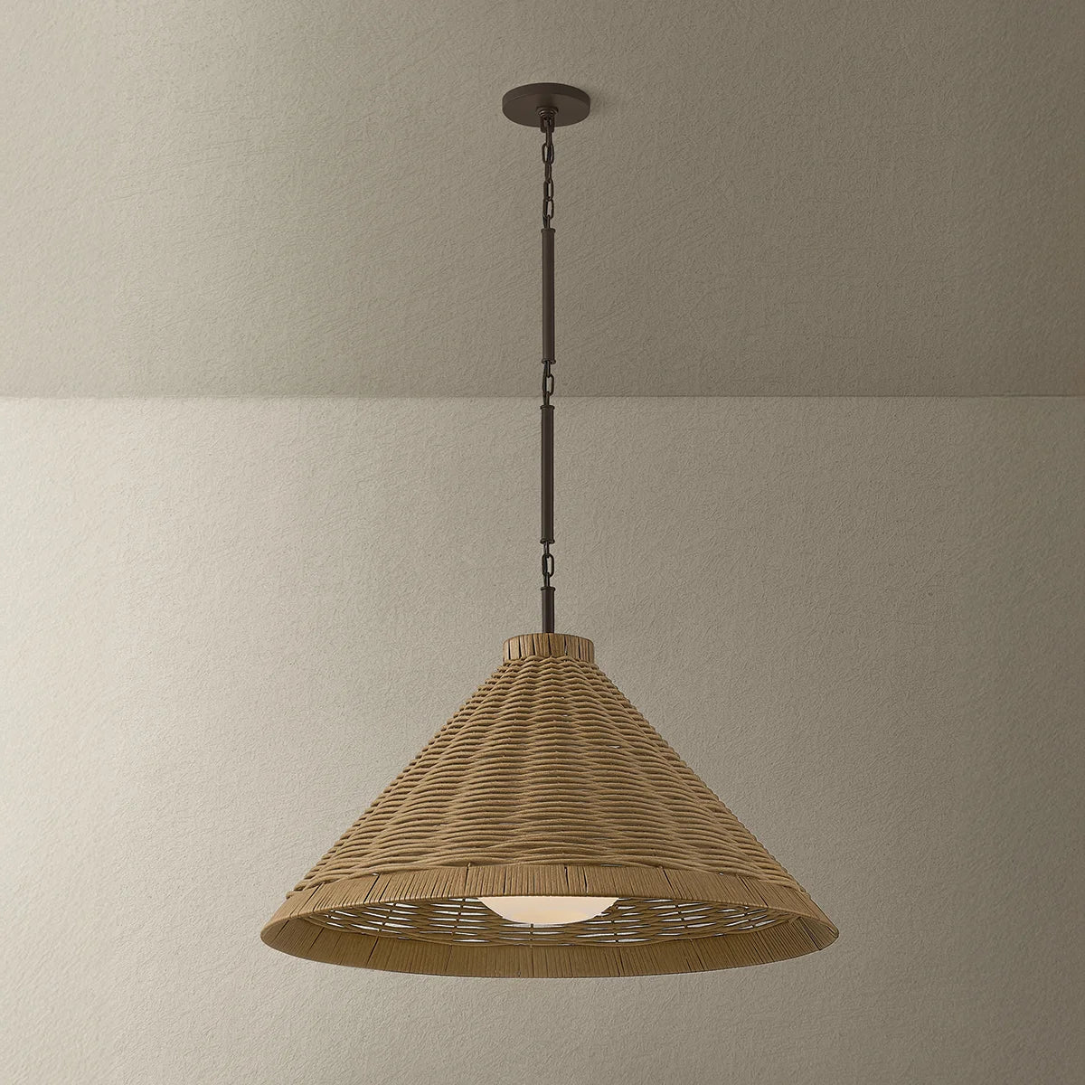 Wicker pendant light hanging against a plain wall