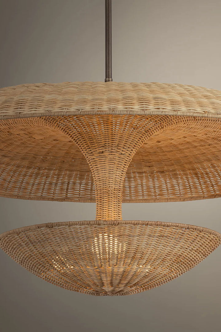 Woven rattan pendant light against a neutral background